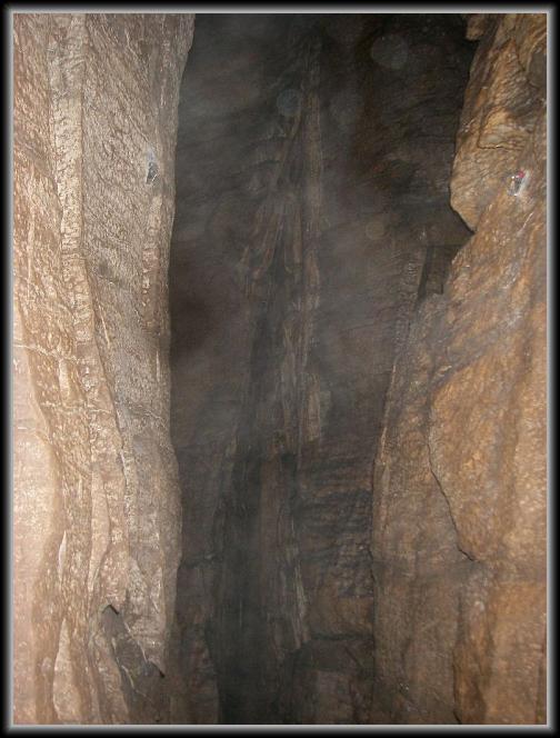 kee-13.JPG - A climbing bolt is pictured on either side of this deep canyon.  There is a bit of red tape on the one on the right. It's maybe a 20' drop to the canyon floor from the ledge I was standing on.